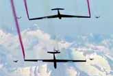 Five Wingsuit Flyers and Two Sailplanes in Tight Formation